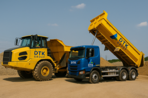 TK Group-branded mini excavator being transported on a trailer for site delivery